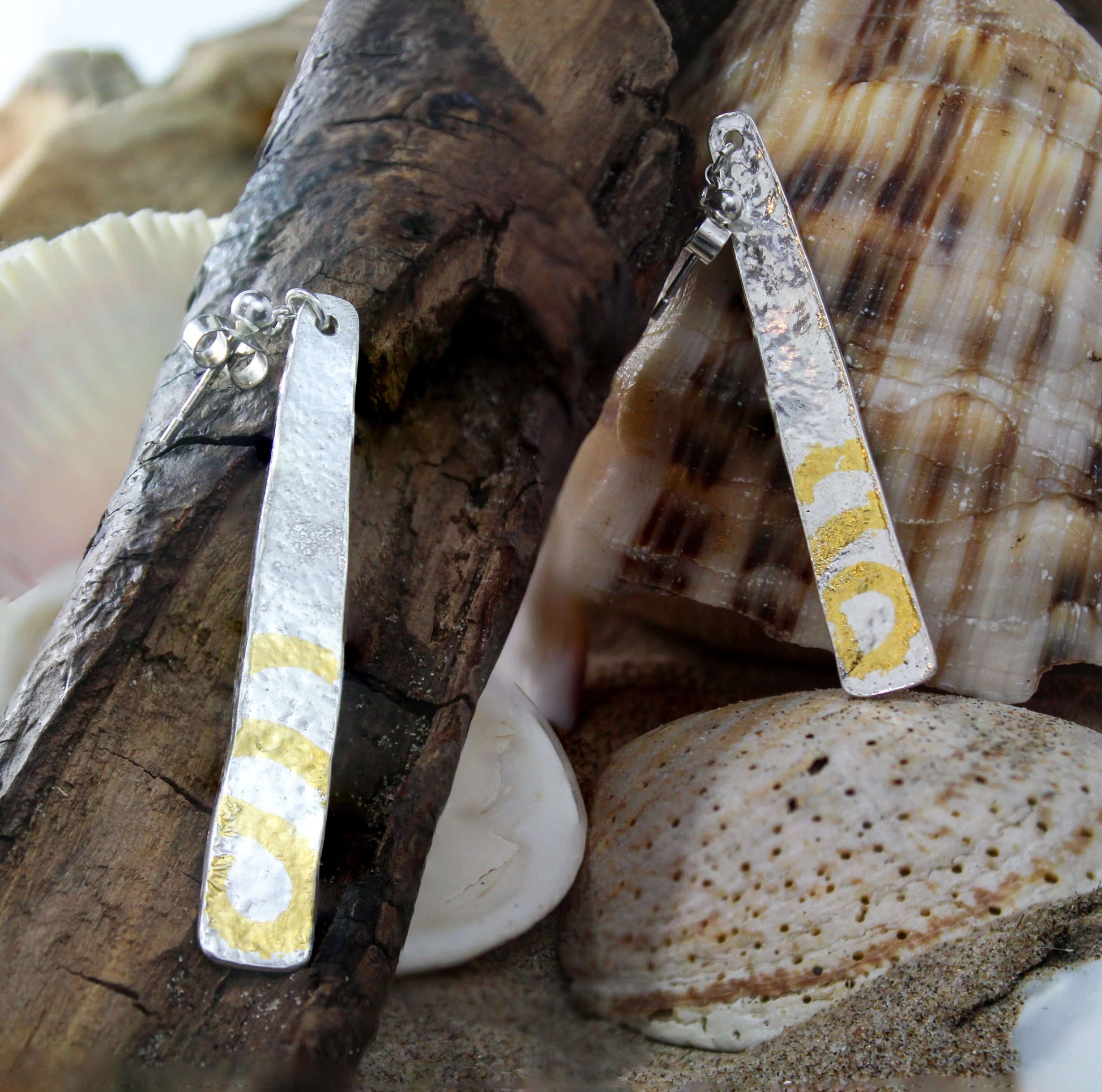 An Ghrian Drop Earrings - Reticulated Silver with Keum Boo 24k Gold displayed on drift wood by Atlantic Rose